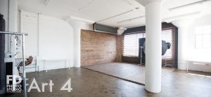 photo studio with wood wall and corner with large wood blinds