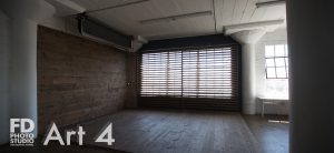 photo studio with wood wall and corner with large wood blinds