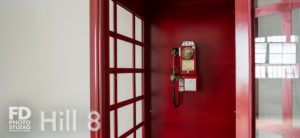 South-East Facing Natural light photo studio with wood barn doors, wood barrels and red phone booth