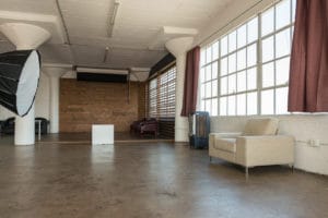 Stage with a wooden corner, large blinds and a marquee star available for rental in Los Angeles