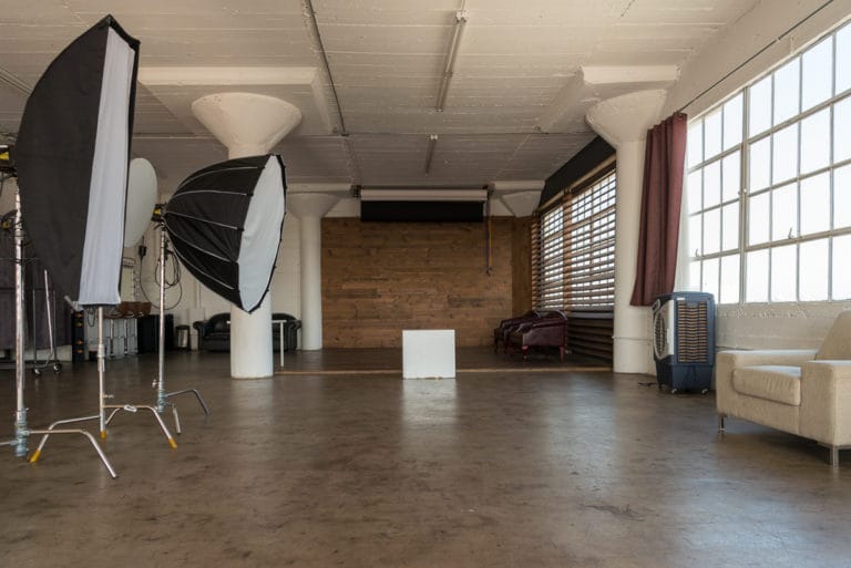 Stage with a wooden corner, large blinds and a marquee star available for rental in Los Angeles