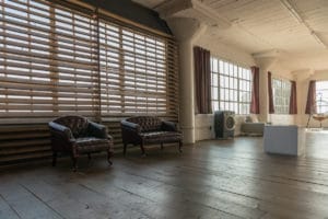 Stage with a wooden corner, large blinds and a marquee star available for rental in Los Angeles