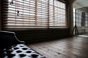 Stage with a wooden corner, large blinds and a marquee star available for rental in Los Angeles