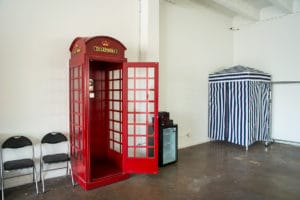 South-East Facing Natural light photo studio with wood barn doors, wood barrels, red phone booth and a rust corner available for photo and video rental in Los Angeles
