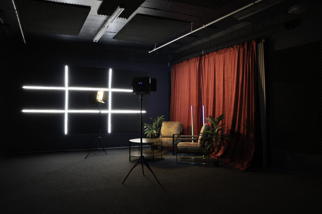 Soundproof Podcast Studio in DTLA with red curtains brick and wooden walls furniture RGB LED lights - Pro III_1