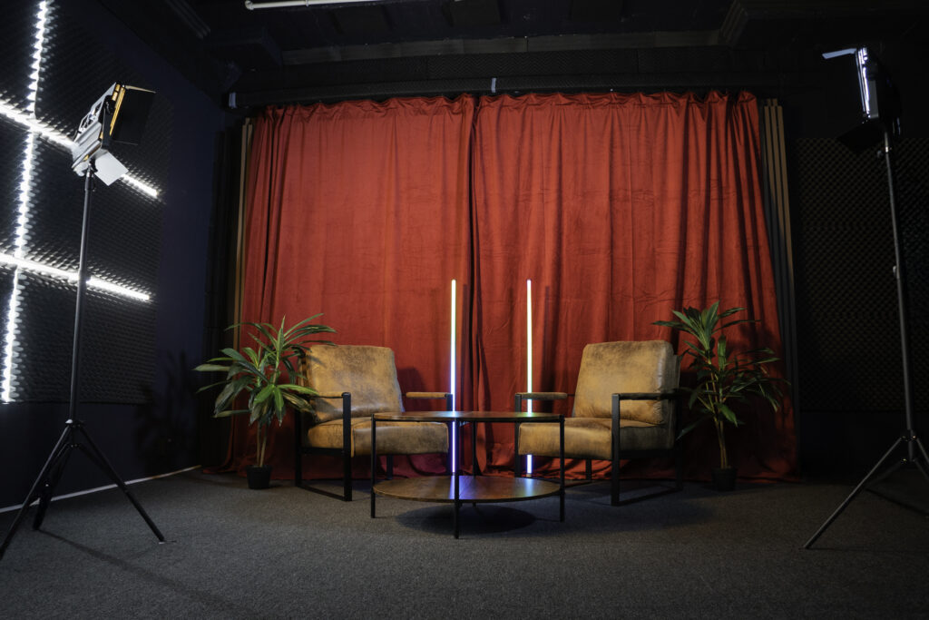 Soundproof Podcast Studio in DTLA with red curtains brick and wooden walls furniture RGB LED lights - Pro III_3