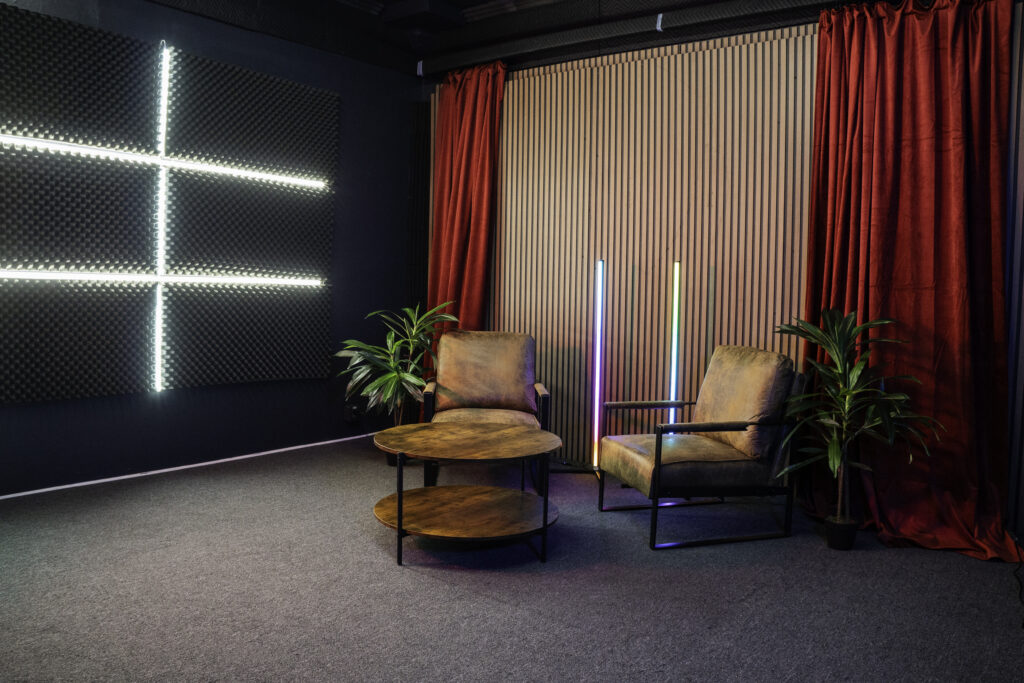 Soundproof Podcast Studio in DTLA with red curtains brick and wooden walls furniture RGB LED lights - Pro III_5
