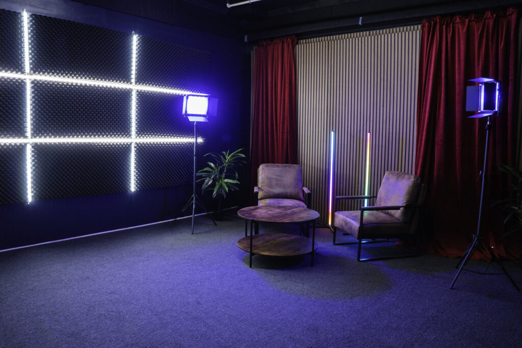 Soundproof Podcast Studio in DTLA with red curtains brick and wooden walls furniture RGB LED lights - Pro III_6
