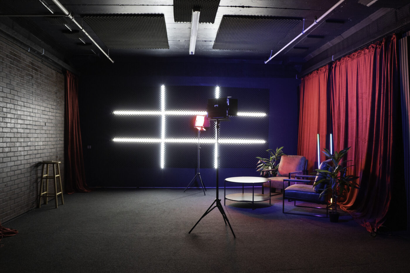 Soundproof Podcast Studio in DTLA with red curtains brick and wooden walls furniture RGB LED lights - Pro III_9