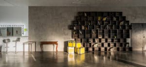 Photo Studio with Book Shelf, yellow cine cases and grey textured wall