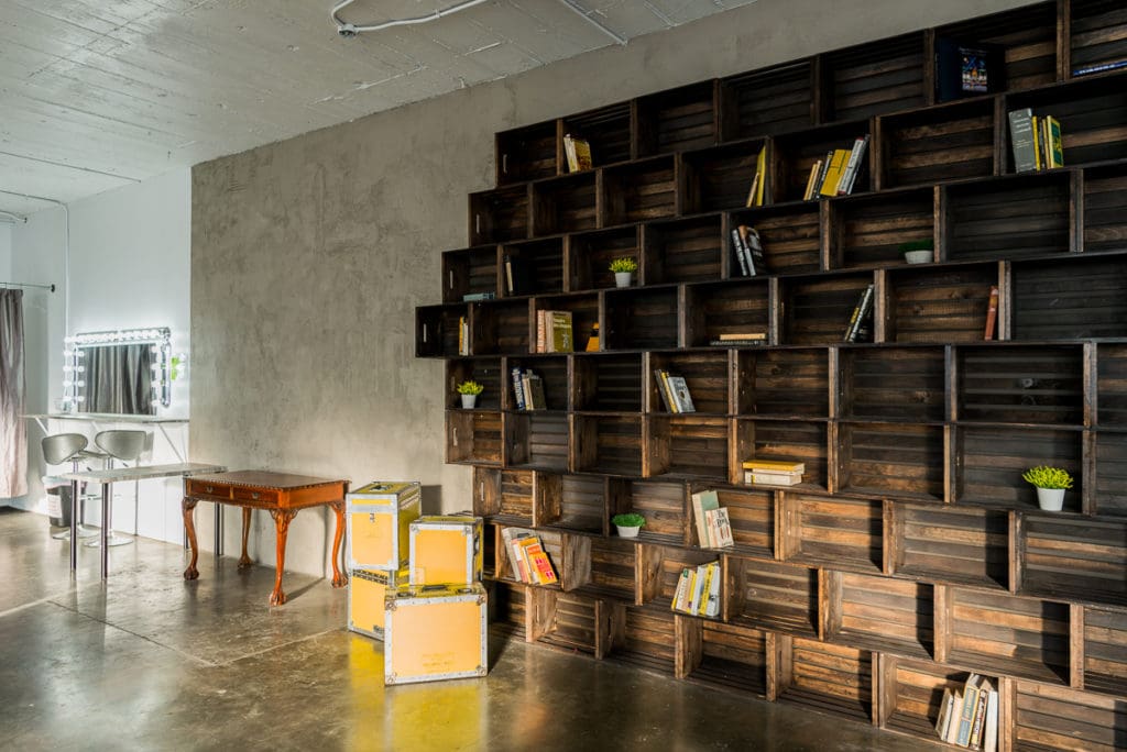 Photo Studio with Book Shelf, yellow cine cases and grey textured wall