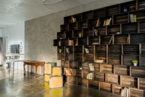 Photo Studio with Book Shelf, yellow cine cases and grey textured wall