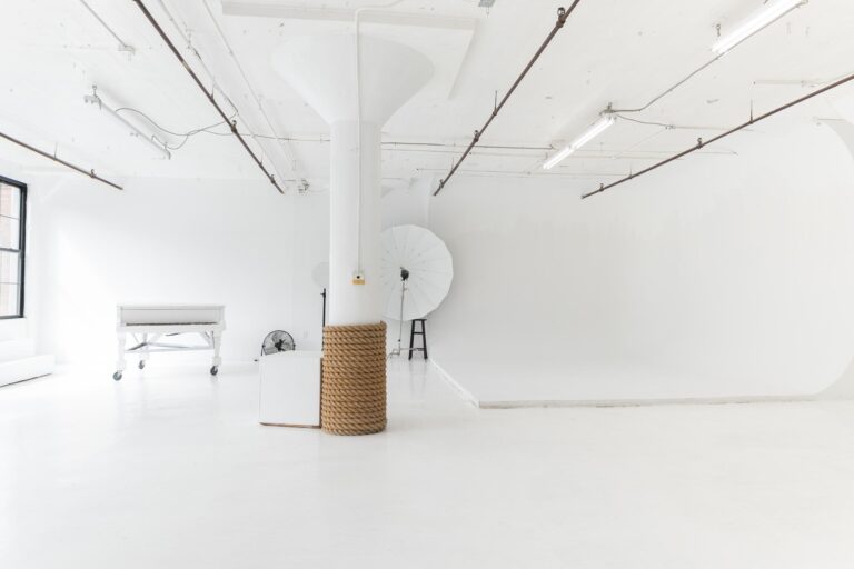 LIC 1 photo studio in Long Island City, NYC with white cyc wall, west-facing windows, natural light, and white floors.
