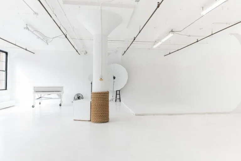 LIC 1 photo studio in Long Island City, NYC with white cyc wall, west-facing windows, natural light, and white floors.