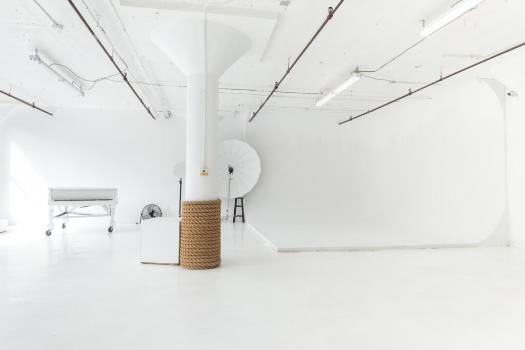 LIC 1 photo studio in Long Island City, NYC with white cyc wall, west-facing windows, natural light, and white floors.