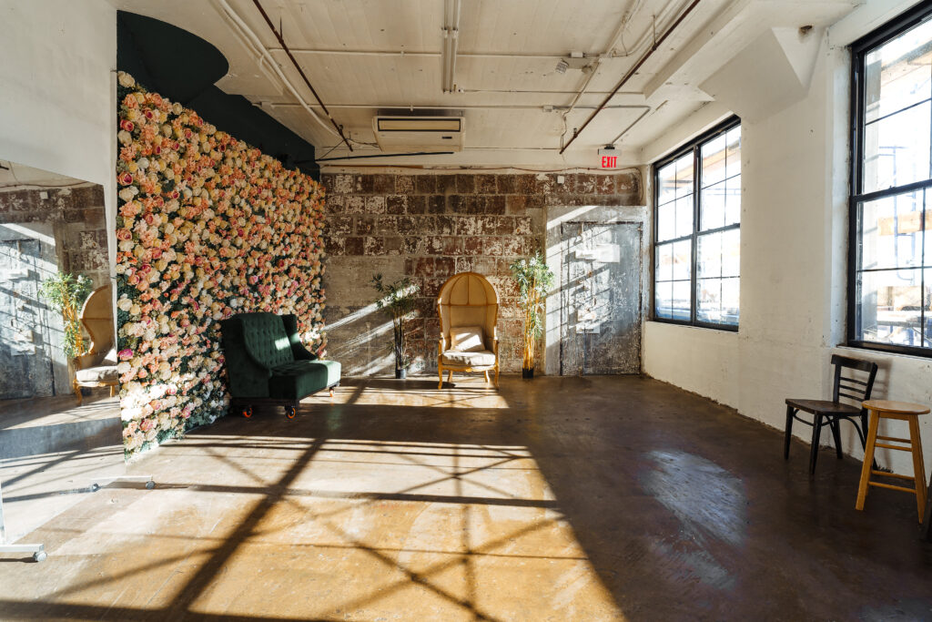 LIC 6 - daylight photo studio for rent near me with flower wall and exposed block wall in New York