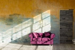 Sunshine studio 7 with a yellow textured wall, moroccan tile and a purple couch available for rental in NYC