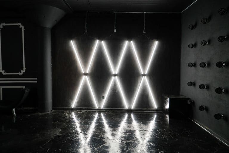 Affordable photo studio with 4 different sets, RGB lights, furniture and additional grip & strobes included, available for rent hourly near New York.