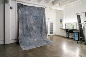 Grey textured fabric backdrop available for rental with Hill 6 photo studio