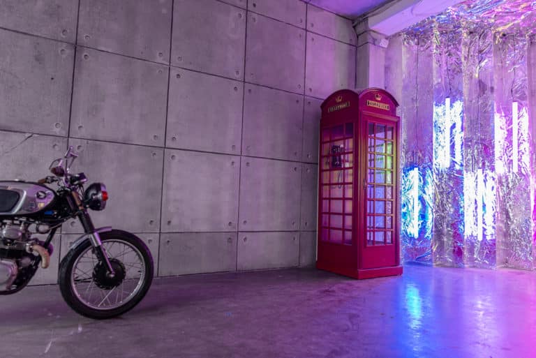 Atmospheric Textured Grey Concrete Wall with Motorcycle and Red Phone Booth available with Hill 8 photo studio rental