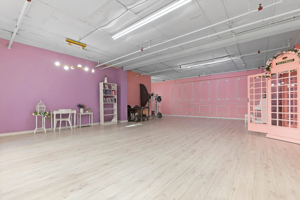 Rental photo studio with hardwood floors, big North facing window, and a pink photo booth - Astoria 3