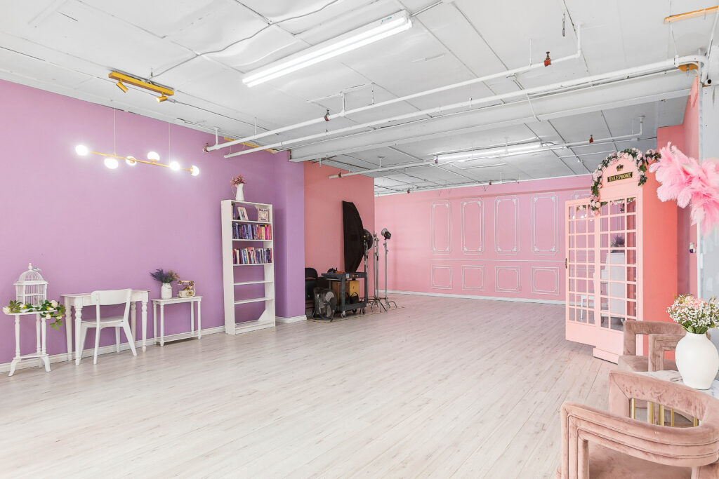 Rental photo studio with hardwood floors, big North facing window, and a pink photo booth - Astoria 3