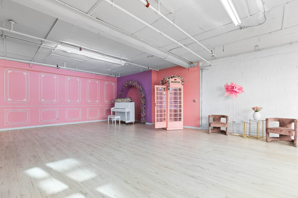 Rental photo studio with hardwood floors, big North facing window, and a pink photo booth - Astoria 3
