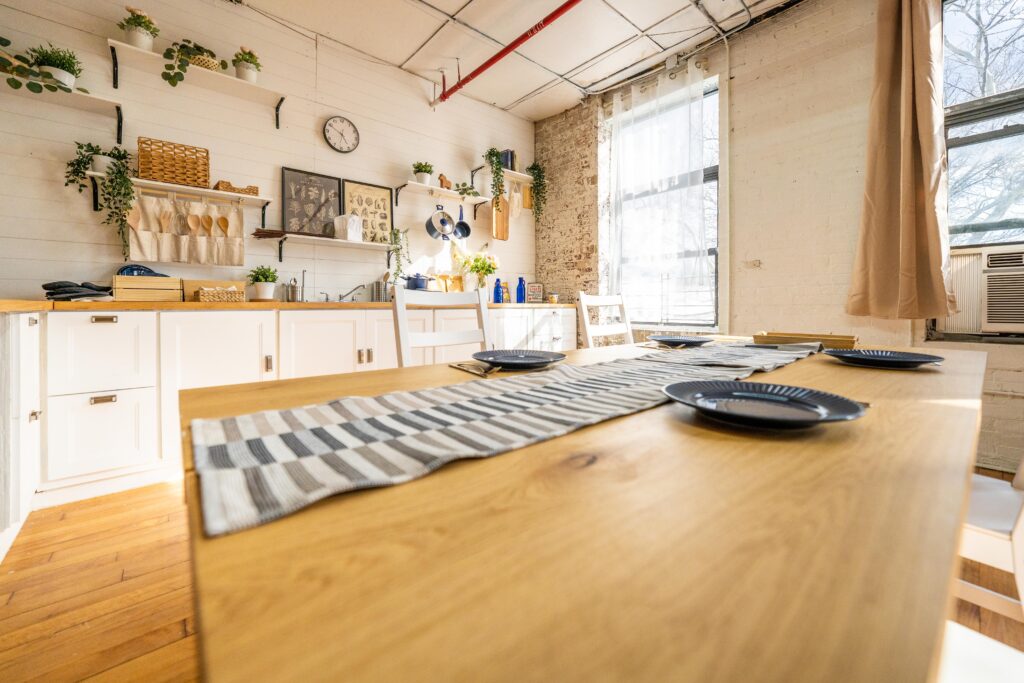 Astoria 5 - Daylight photo studio with kitchen, wood floor and cozy couch in New York