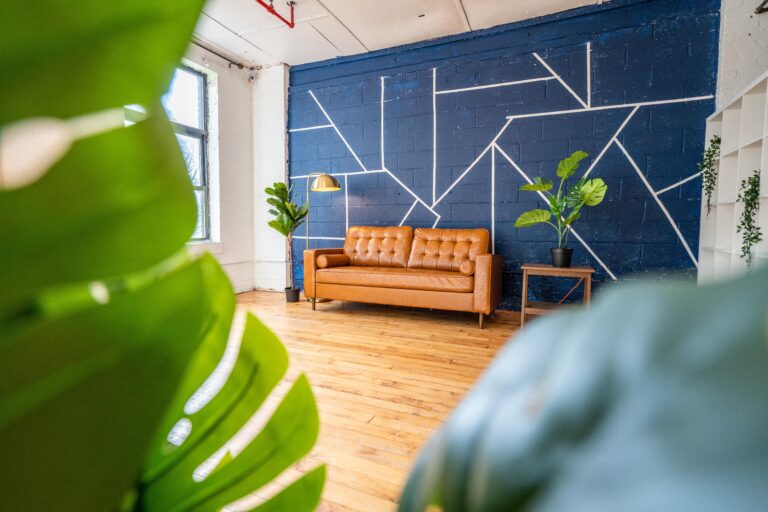 Astoria 5 - Daylight photo studio with kitchen, wood floor and cozy couch in New York