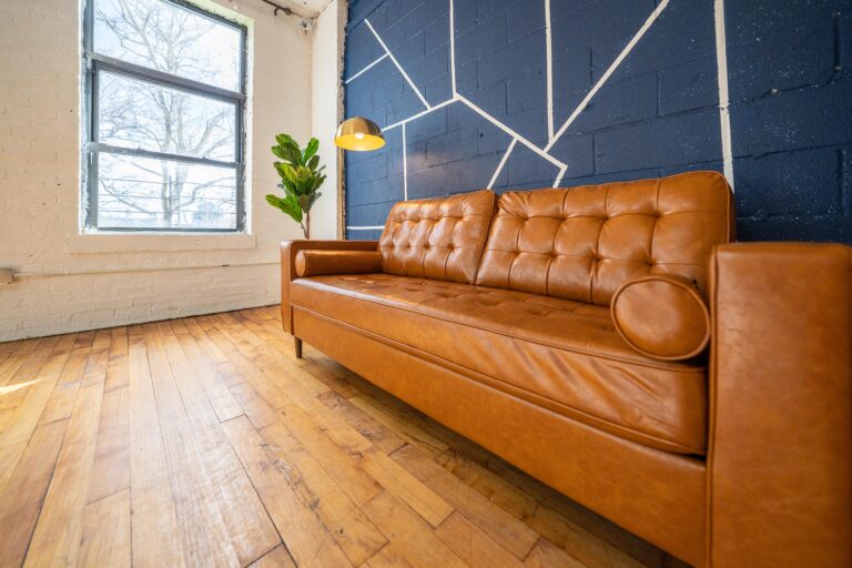 Astoria 5 - Daylight photo studio with kitchen, wood floor and cozy couch in New York