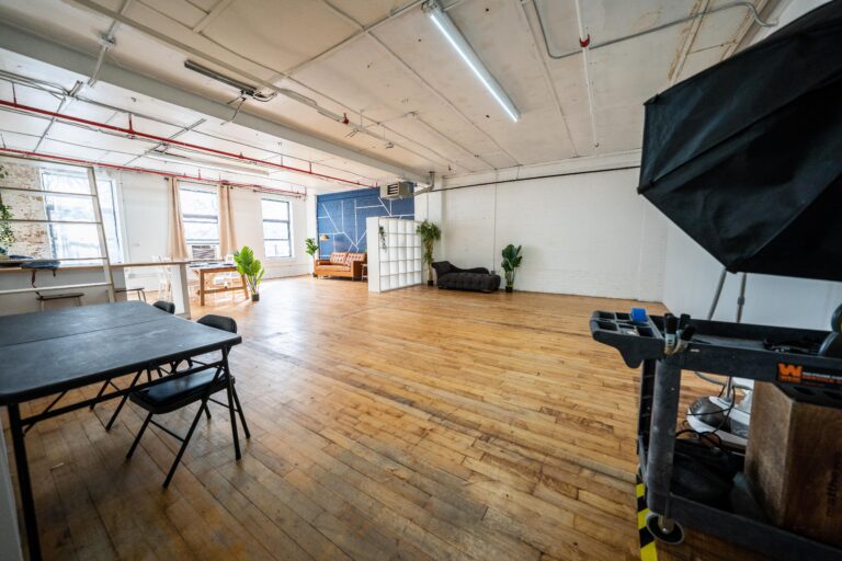 Astoria 5 - Daylight photo studio with kitchen, wood floor and cozy couch in New York