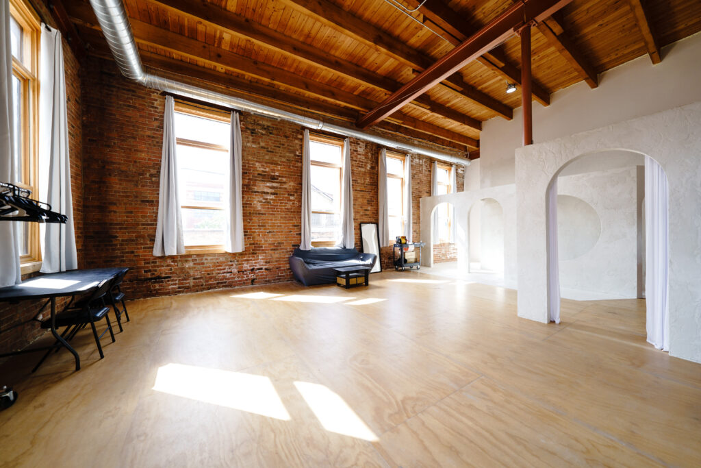 Daylight photo studio for rent in Chicago with corner windows, white arches near me Chicago 7